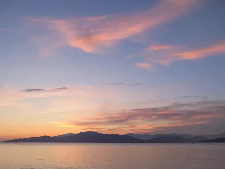 Pink clouds over the ocean at sunset