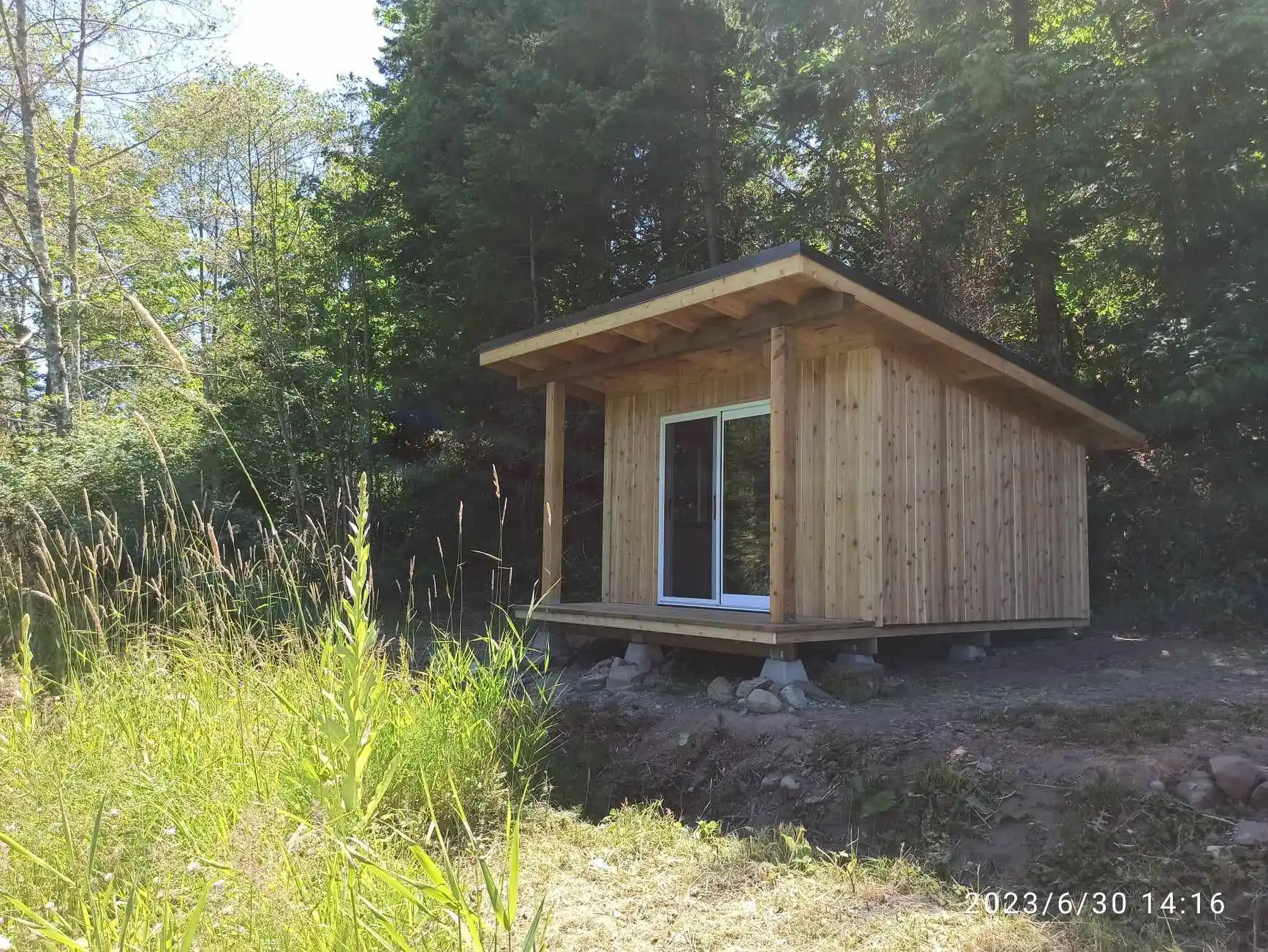 Private wooden cabin accommodation at Neptune Farm set in forest clearing