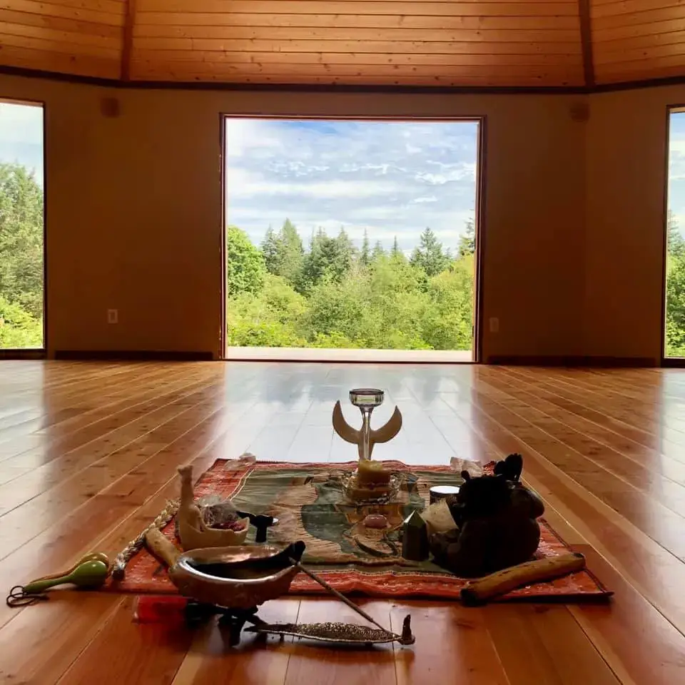 Interior of Neptune Farm temple with altar and open view to forest